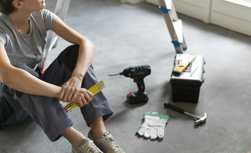 image of a woman sitting besides the repair toolkit